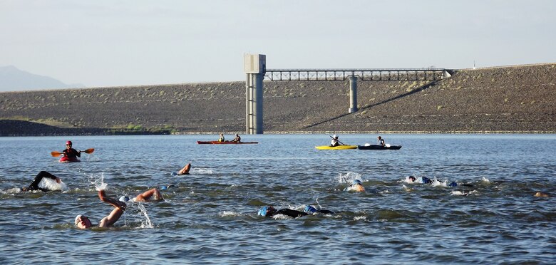 COCHITI LAKE, N.M., -- Cochiti Lake hosted portions of Chasing 3's Cochiti Lake Triathlon July 29, 2012.  Pictured here is the swimming portion of the race, with Cochiti Dam in the background.