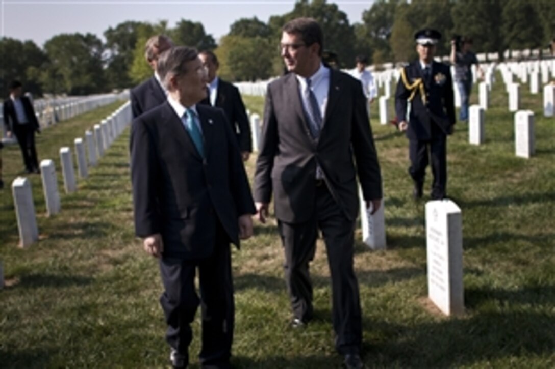 U.S. Deputy Defense Secretary Ashton B. Carter, right, hosts Japanese Defense Minister Satoshi Morimoto, left, during a tour of Arlington National Cemetery's Section 60 in Arlington, Va., Aug. 4, 2012. The leaders also visited the Tomb of the Unknown Soldier.