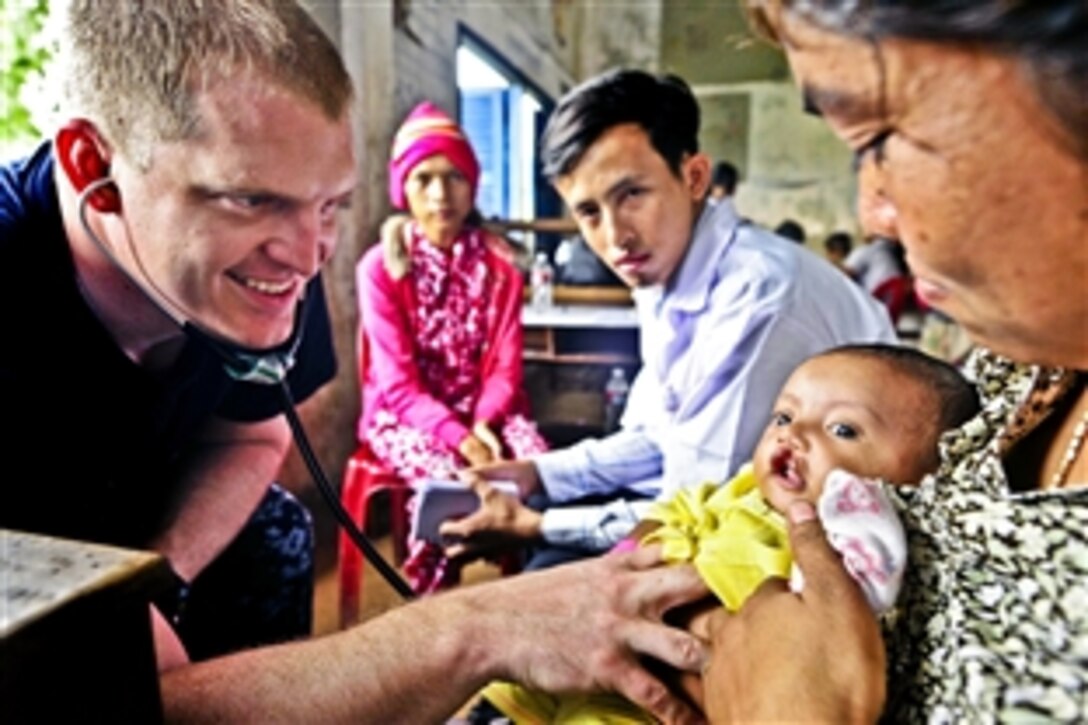 U.S. Navy Lt. Thom Miller listens to the heart of a Cambodian girl during a medical civic action project at Hun Sen Cheungkor Primary School during Pacific Partnership 2012 in Sihanoukville, Cambodia, July 31, 2012.