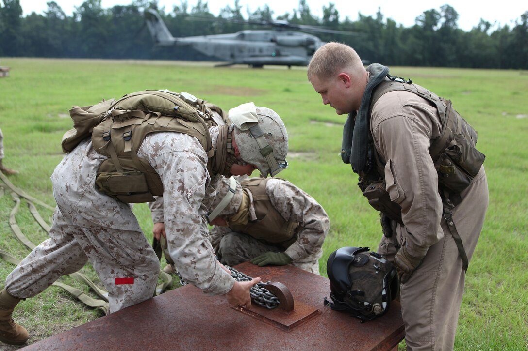 Marines with Combat Logistics Battalion 8, 2nd Marine Logistics Group secure load-bearing ropes to simulated cargo before attaching the load to a Sikorsky CH-53E Super Stallion during a training mission near Camp Lejeune, N.C., July 24, 2012. The simulated cargo mimics the weight of supplies and equipment, which allows the team to prepare for difficult supply missions to Marines deployed to remote parts of Afghanistan.