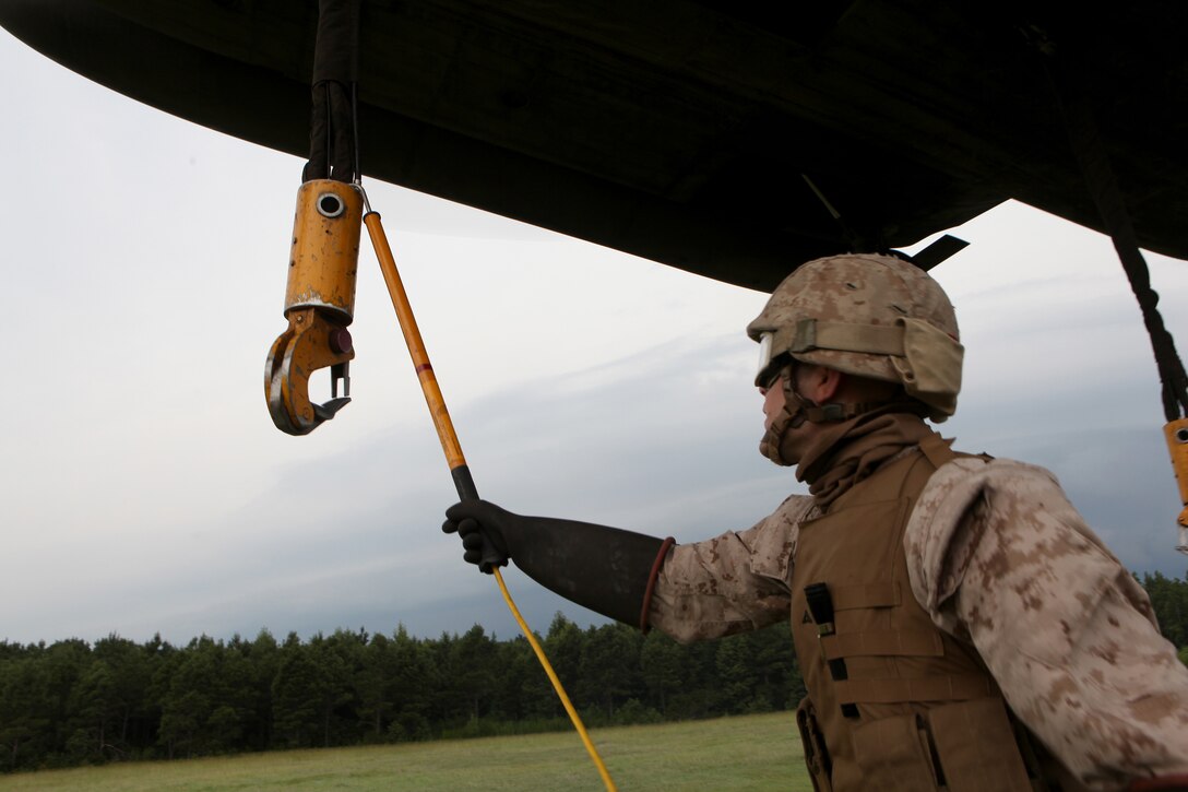 Lance Cpl. Joseph McGaha, a landing support specialist with Combat Logistics Battalion 8, 2nd Marine Logistics Group, attaches a static line to compensate for the electrical build-up of the Sikorsky CH-53E Super Stallion during a training mission near Camp Lejeune, N.C., July 24, 2012. The Super Stallion’s ability to carry internal and external loads helps Marines quickly transport needed war supplies to geographically dispersed areas.