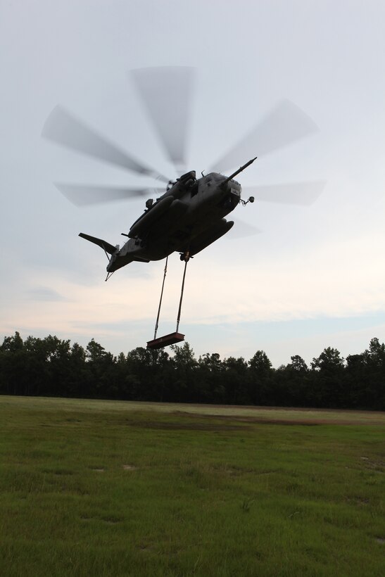A Sikorsky CH-53E Super Stallion departs Training Landing Zone Phoenix with cargo attached by a Helicopter Support Team with Combat Logistics Battalion 8, 2nd Marine Logistics Group during a training mission near Camp Lejeune, N.C., July 24, 2012. The Super Stallion’s ability to carry internal and external loads helps Marines quickly transport needed war supplies to geographically dispersed areas.
