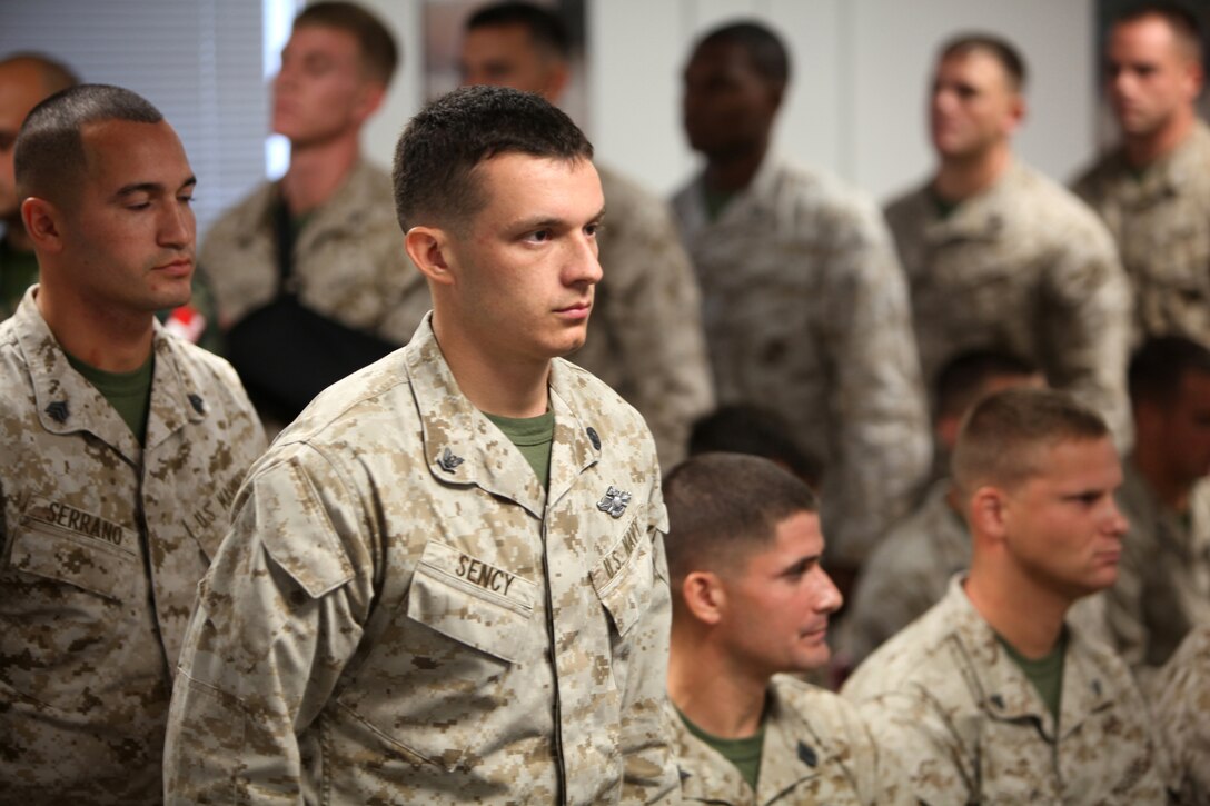 Petty Officer 3rd Class Michael J. Sency, a religious program specialist with 2nd Marine Logistics Group, waits for his name to be called to receive his belt during a Marine Corps Martial Arts Program Instructor course graduation ceremony aboard Camp Geiger, N.C., Aug. 1, 2012. The course included 100 hours of instruction and grueling practical application in a fast-paced training environment.  Sency graduated the course aboard Camp Geiger, N.C., Aug. 1, 2012.  Sency is now part of a very small group of RPs who are qualified to teach Marine Corps Martial arts. 