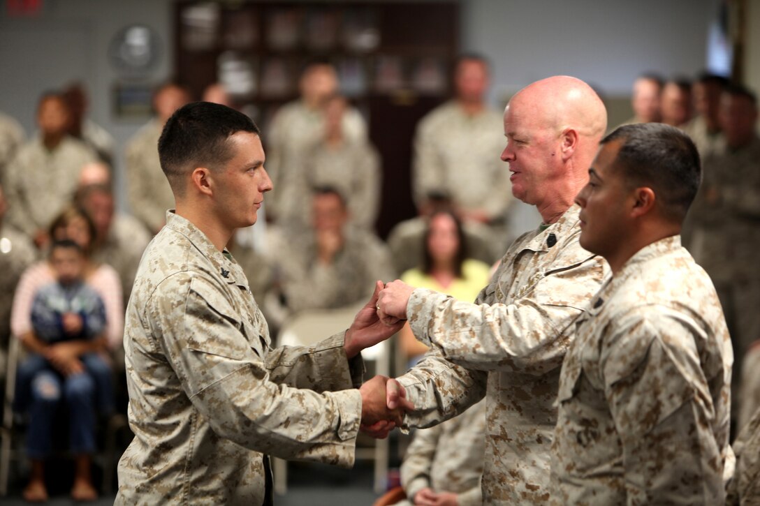 Petty Officer 3rd Class Michael J. Sency (left), a religious program specialist with 2nd Marine Logistics Group, receives his belt from Sgt. Maj. Timothy R. Weber, the director of the Staff Noncommissioned Officer Academy, Camp Johnson, N.C., during a Marine Corps Martial Arts Program Instructor course graduation aboard Camp Geiger, N.C., Aug. 1, 2012. The course included 100 hours of instruction and grueling practical application in a fast-paced training environment.  Sency graduated the course aboard Camp Geiger, N.C., Aug. 1, 2012.  Sency is now part of a very small group of RPs who are qualified to teach Marine Corps Martial arts.