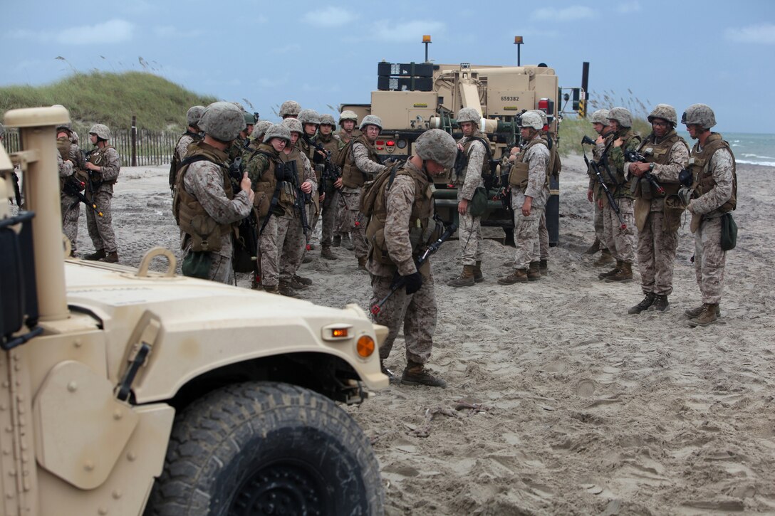 Cpl. Justin P. Glover, a wrecker operator with Combat Logistics Battalion 8, 2nd Marine Logistics Group, demonstrates how to pull a Humvee stuck in the sand with a wrecker during a field training exercise aboard Camp Lejeune, N.C., July 31, 2012.  The troops trained in many ways to improve their skills and confidence operating the vehicles in different terrains.  The week-long exercise was designed to prepare the troops for their upcoming deployment to Afghanistan.