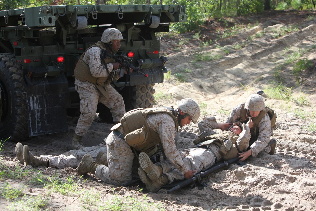 A group of Marines with Combat Logistics Battalion 8, 2nd Marine Logistics Group care for a simulated casualty after their truck hit a simulated improvised explosive device during a field training exercise aboard Camp Lejeune, N.C., Aug. 1, 2012.  The troops experienced multiple situations such as simulated firefights, explosions and casualty evacuations, which added realism to their pre-deployment training.  The battalion’s week-long field exercise was designed to prepare the troops for their upcoming deployment to Afghanistan.  
