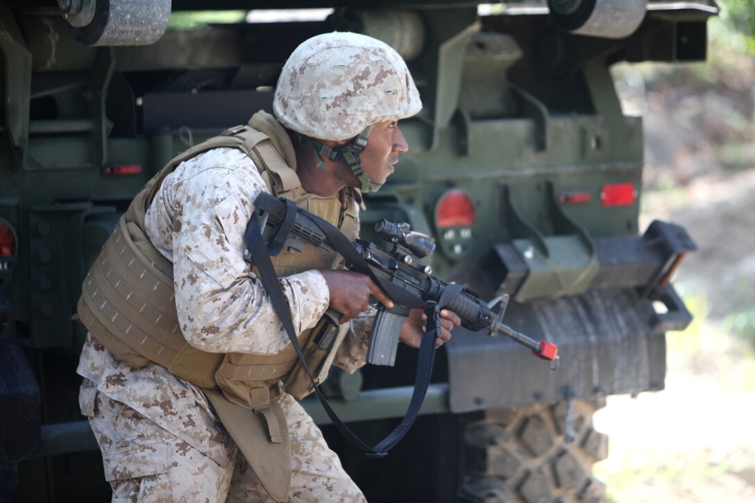 Sgt. Bryan N. Butts, a motor vehicle operator with Combat Logistics Battalion 8, 2nd Marine Logistics Group, provides security as his troops recover a simulated casualty after their truck hit a simulated improvised explosive device during a field training exercise aboard Camp Lejeune, N.C., Aug. 1, 2012. Servicemembers with the battalion had to endure many situations during the week-long exercise such as firefights, explosions and casualty evacuations as part of their pre-deployment training.  The troops are preparing for their upcoming deployment to Afghanistan.