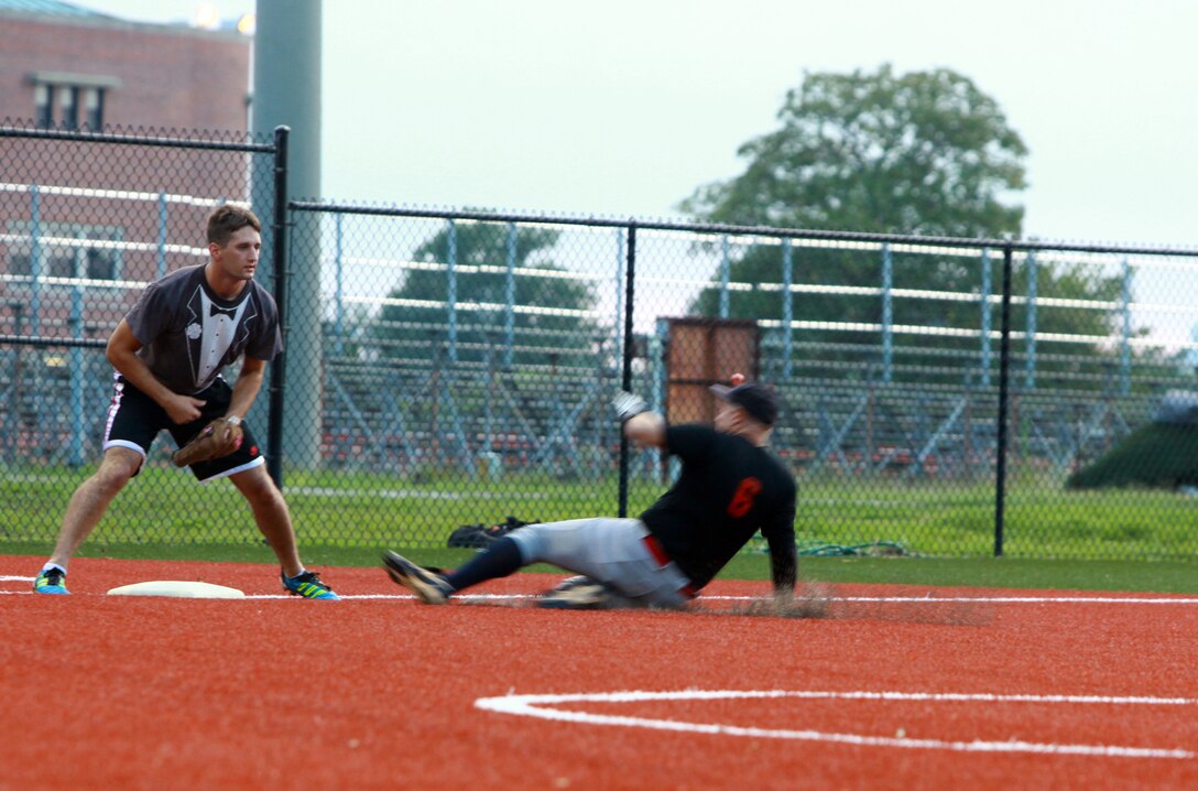 Lance Cpl. William Campion II, the shortstop for the “Dirty Herd”, slides into third base during a softball game aboard Camp Lejeune, N.C., Aug. 2, 2012. Campion is a Marine with Combat Logistics Regiment 2, 2nd Marine Logistics Group. (Photo by Sgt. Rachael K. A. Moore)