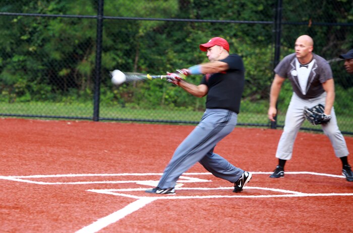 Cpl. Cody A. Sanborn, an outfielder for "Dirty Herd", smacks a line drive to left field during a softball game at Camp Lejeune, N.C., Aug. 2, 2012.  Dirty Herd is made up of Marines from Combat Logistics Regiment 2, 2nd Marine Logistics Group.  Off the field, Sanborn is a logistics vehicle system operator.  (Photo by Sgt. Rachael K. A. Moore)