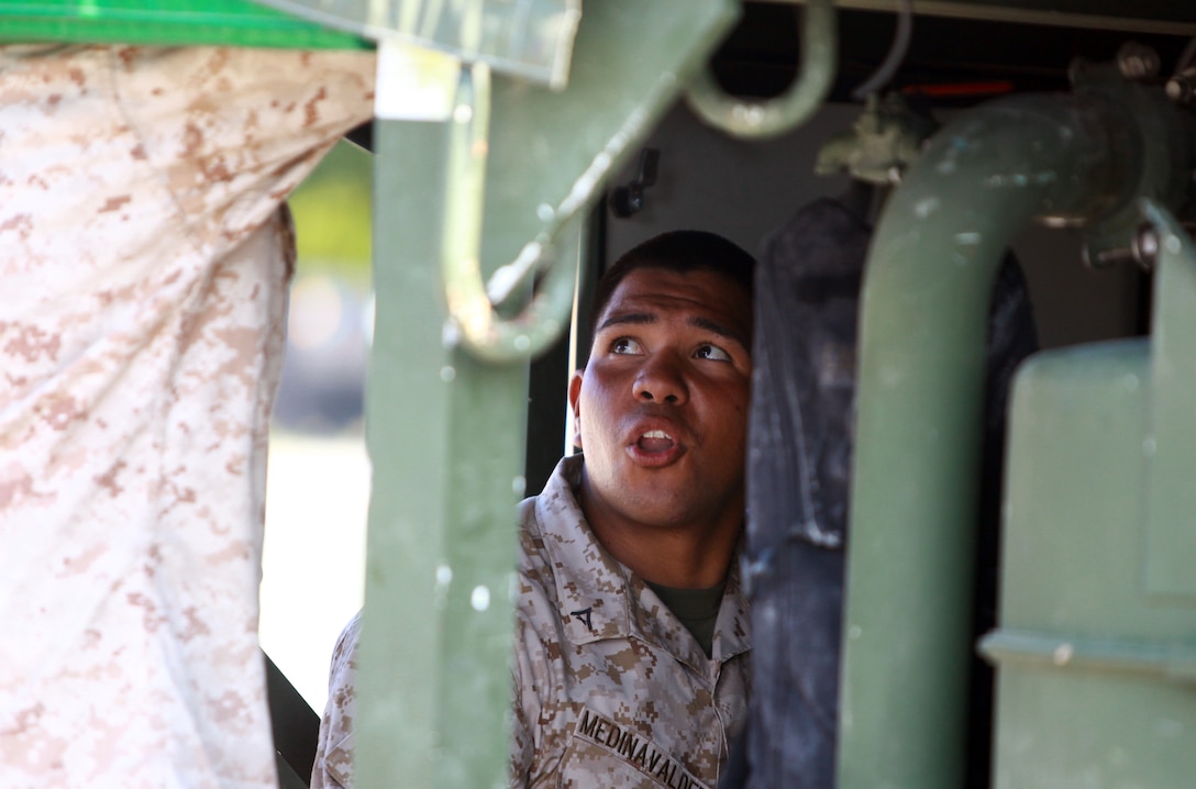 Lance Cpl. Mario MedenaValdez, a water support technician with 8th Engineer Support Battalion, 2nd Marine Logistics Group, explains how to use the Tactical Water Purification System during a training exercise at Mile Hammock Bay aboard Camp Lejeune, N.C., July 25, 2012. Along with conducting training to refresh their own skills, 8th ESB was joined by Marines with 6th ESB, the battalion’s reserve counterpart. (U.S. Marine Corps photo by Pfc. Franklin E. Mercado)