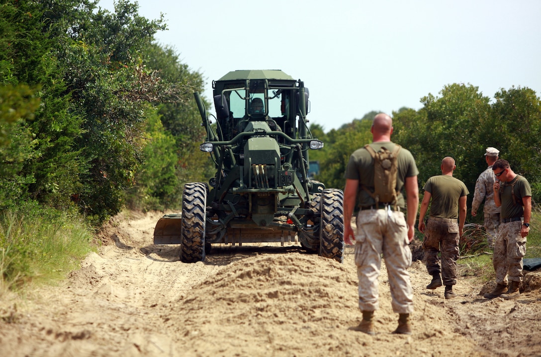 Marines with 8th Engineer Support Battalion, 2nd Marine Logistics Group guide a multi-purpose tractor during a field exercise at Mile Hammock Bay aboard Camp Lejeune, N.C., July 25, 2012. 8th ESB used the training as a chance to prepare for a field exercise called Joint Logistics Off Shore Exercise scheduled for August. (U.S. Marine Corps photo by Pfc. Franklin E. Mercado)