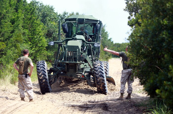 Marines with 8th Engineer Support Battalion, 2nd Marine Logistics Group guide a multi-purpose tractor during a field exercise at Mile Hammock Bay aboard Camp Lejeune, N.C., July 25, 2012. 8th ESB used the training as a chance to prepare for a field exercise called Joint Logistics Off Shore Exercise scheduled for August.  (U.S. Marine Corps photo by Pfc. Franklin E. Mercado)