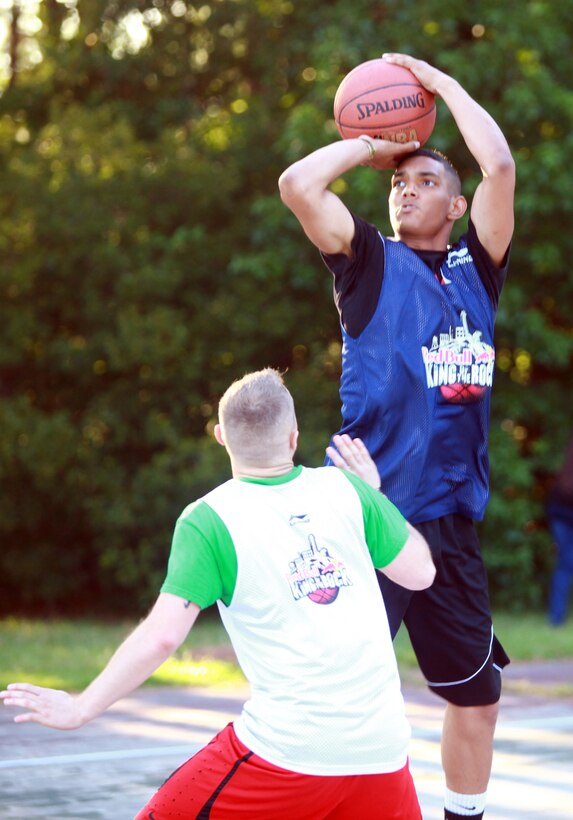 Pfc. Eddy D. TineoMateo, an administrative specialist with Combat Logistics 27, 2nd Marine Logistics Group, takes a shot over his opponent during the Red Bull King of the Rock tournament aboard Camp Lejeune, N.C., July 18, 2012. Mateo, a Staten Island, N.Y., native has played basketball since eighth grade and doesn’t plan on giving it up. (U.S. Marine Corps photo by Pfc. Franklin E. Mercado)