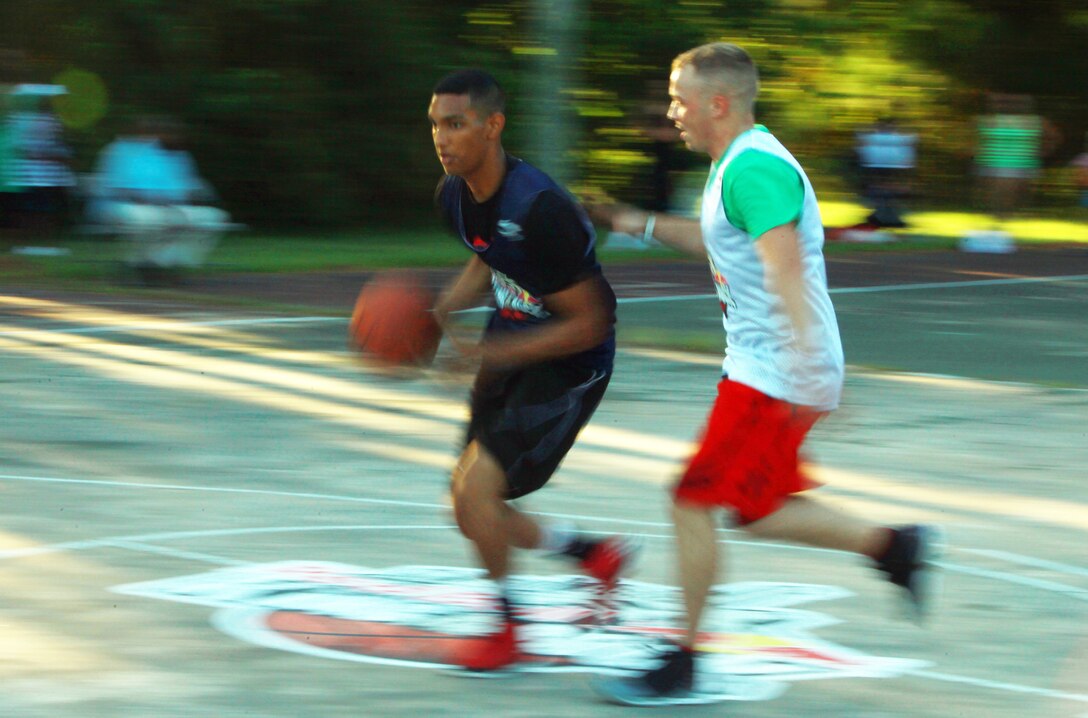 Pfc. Eddy D. TineoMateo, an administrative specialist with Combat Logistics 27, 2nd Marine Logistics Group, blows past his opponent during the Red Bull King of the Rock tournament aboard Camp Lejeune, N.C., July 18, 2012. Mateo, a Staten Island, N.Y., native has played basketball since eighth grade and doesn’t plan on giving it up. (U.S. Marine Corps photo by Pfc. Franklin E. Mercado)