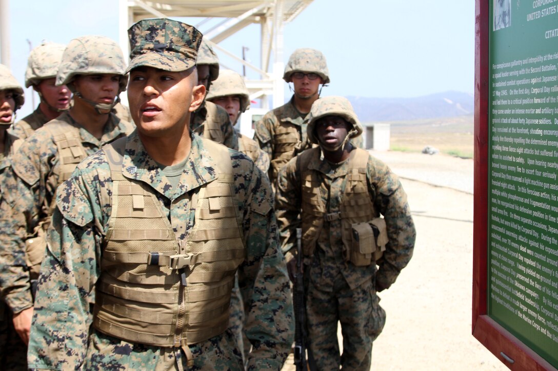 Sgt. Isidro Cobos, drill instructor, Platoon 2122, Company F, 2nd Recruit Training Battalion, reads an award citation to his recruits at Edson Range aboard Marine Corps Base Camp Pendleton, Calif. After the reading, recruits lined up to shoot targets at unknown distances. Their shooting scenarios varied from shooting through a window to shooting on burst from a bunker.