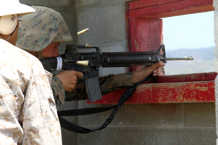 A Company F, 2nd Recruit Training Battalion recruit fires his weapon on burst from a bunker at Edson Range aboard Marine Corps Base Camp Pendleton, Calif. July 31. The exercise provided the recruits their first opportunity to fire their rifles on burst. After finishing the exercise recruits formed up to continue their three day Crucible filled with numerous other exercises designed to test their mental and physical fortitude.