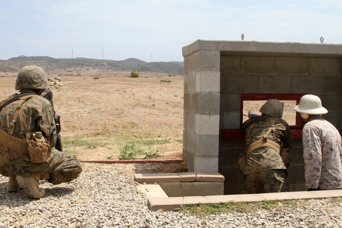Company F, 2nd Recruit Training Battalion recruits take turns firing down range at unknow distanced targets at Edson Range aboard Marine Corps Base Camp Pendleton, Calif. July 31. The exercise was just one of many during the recruits three day Crucible. During the last segment of the exercise, recruits had their first opportunity to fire weapons on burst. 