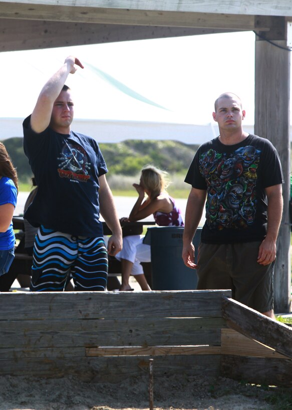 Two Marines with 8th Engineer Support Battalion, 2nd Marine Logistics Group play horseshoes during the battalion’s fun day at Onslow Beach aboard Camp Lejeune, N.C., July 19, 2012. During the event, Marines and sailors enjoyed food, drinks, family and friends while taking a day off from work. (U.S. Marine Corps photo by Pfc. Franklin E. Mercado)