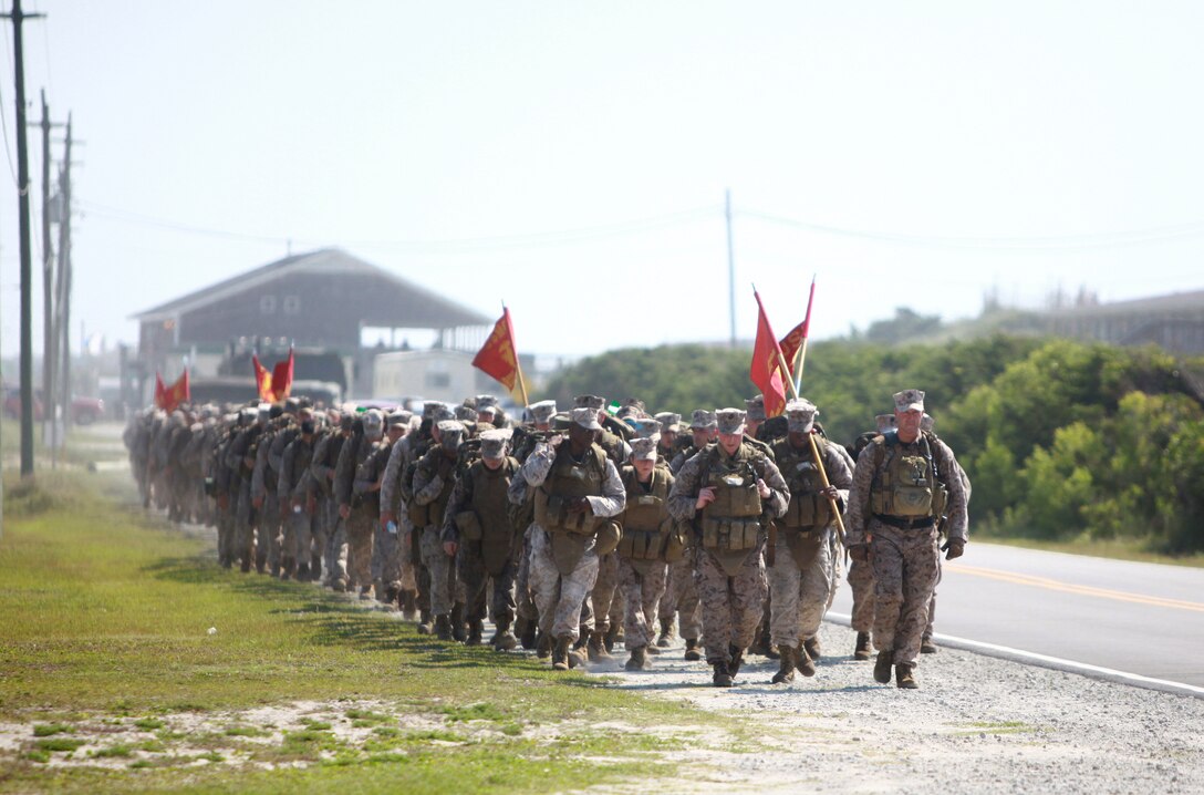 Marines and sailors with 8th Engineer Support Battalion, 2nd Marine Logistics Group hike to Onslow Beach aboard Camp Lejeune, N.C., July 19, 2012. After the hike, the unit enjoyed a fun day with family and friends. (U.S. Marine Corps photo by Pfc. Franklin E. Mercado)