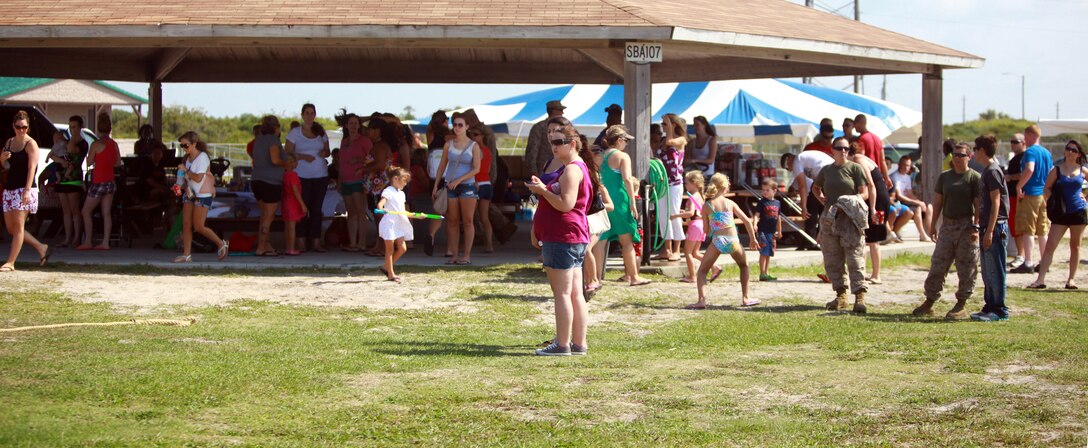 Marines, sailors, families and friends await the arrival of their loved ones during a beach day aboard Camp Lejeune, N.C., July 19, 2012. During the event, Marines and sailors with 8th Engineer Support Battalion, 2nd Marine Logistics Group took a day off from work and enjoyed fun at the beach. However, before the festivities began the battalion’s Marines and sailors were put to the test during an eight-mile hike, which started at the unit’s headquarters and ended at the beach. (U.S. Marine Corps photo by Pfc. Franklin E. Mercado)