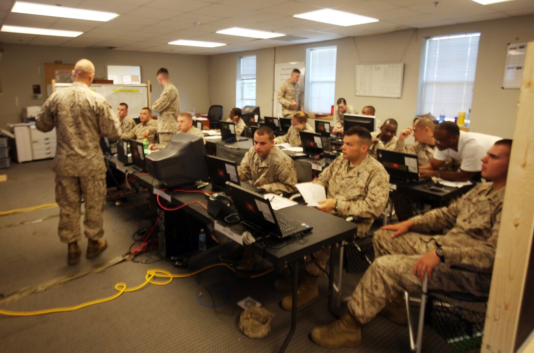 Marines and sailors slated to deploy with Combat Logistics Battalion 8, 2nd Marine Logistics Group listen to a brief at the battalion’s combat operations center aboard Camp Lejeune, N.C., July 24, 2012. A unit’s COC is an epicenter of information and logistics. (U.S. Marine Corps photo by Pfc. Franklin E. Mercado)
