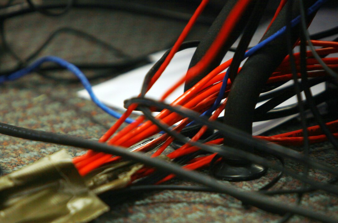 Wires run throughout the mock combat operations center ran by Combat Logistics Battalion 8, 2nd Marine Logistics Group aboard Camp Lejeune, N.C., July 24, 2012. In the COC, everyone works together using an intricate system or programs and networks which help Marines keep the unit’s information organized. (U.S. Marine Corps photo by Pfc. Franklin E. Mercado)
