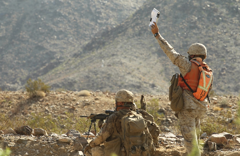 A Tactical Training Exercise Control Group evaluator raises his notebook to signal other members of the evaluation team July 29, 2012 during an exercise with Company F, 2nd Battalion, 7th Marine Regiment at Range 400 during Enhanced Mojave Viper., Lance Cpl. D.J. Wu, 7/28/2012 8:00 PM