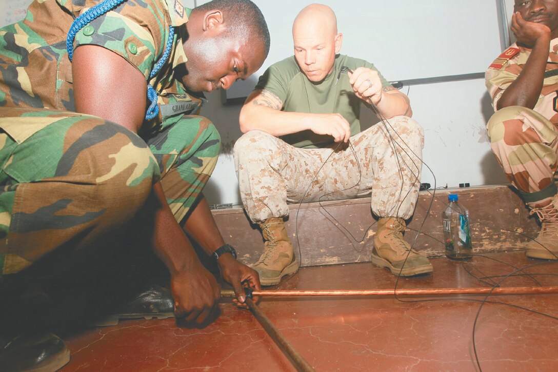 Ghana Army Lt. John M. Baluo, commucations officer, 2nd Signal Squadron, sets up a Very High Frequency field explorer antenna during the final exercise in a week-long electronic communications course July 27, 2012 as part of the Military to Military Communication Exchange program. 