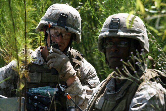 Cpl. Aaron Michaels (left), a squad leader with 2nd Battalion, 2nd Marine Regiment, 2nd Marine Division, radios in a faux improvised explosive device. Marines and sailors with Company E, 2nd Battalion, 2nd Marine Regiment, 2nd Marine Division, practiced counter-IED training July 30- August 2. 