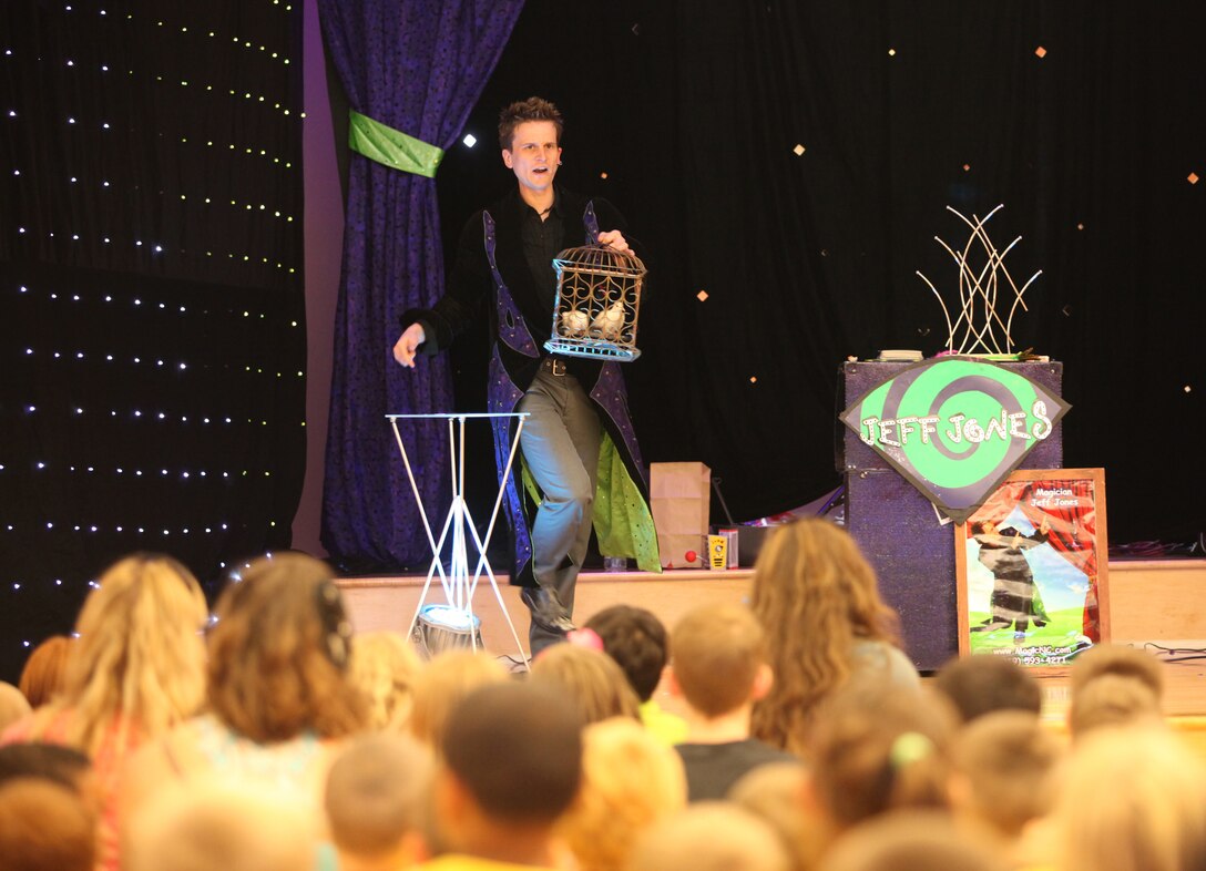 Magician Jeff Jones dazzles the crowd with doves he pulled from thin air at the grand finale of the summer reading program at Marston Pavilion aboard Marine Corps Base Camp Lejeune Aug. 3. Children between the ages of four and 11 were amazed as Jones made other objects appear and then vanish before their eyes.