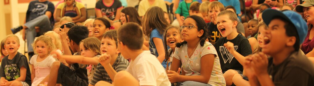 A group of military children look on in laughter and awe as Magician Jeff Jones dazzles the crowd at the grand finale of the summer reading program at Marston Pavilion aboard Marine Corps Base Camp Lejeune Aug. 3. Jones’ act thrilled the audience with disappearing birds, magic wands and even a rat.