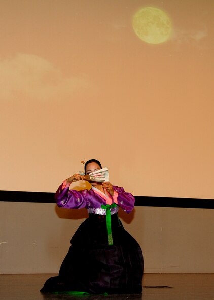 A member of the Samulnori group performs a traditional Korean dance during a concert in the base theater at Kunsan Air Base, Republic of Korea, Aug. 06, 2012. The Samulnori has its roots in “nong-ak,” a type of Korean folk music used to celebrate harvests. (U.S. Air Force photo/Senior Airman Marcus Morris)