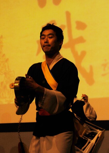 A member of the Samulnori group plays a kkwaenggawari, (small gong) during a concert in the base theater at Kunsan Air Base, Republic of Korea, Aug. 6, 2012. The group performed folk songs along with choreographed dancing with traditional Korean instruments. (U.S. Air Force photo/Senior Airman Marcus Morris)