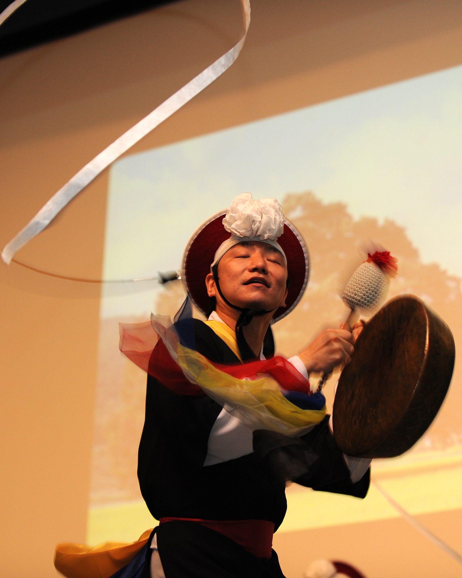 A member of a Samulnori group plays a kkwaenggawari (small gong) during a concert in the base theater on Kunsan Air Base, Republic of Korea, Aug. 6, 2012. The concert included Samulnori performances, singing and dancing. (U.S. Air Force photo/Staff Sgt. Jonathan Fowler)