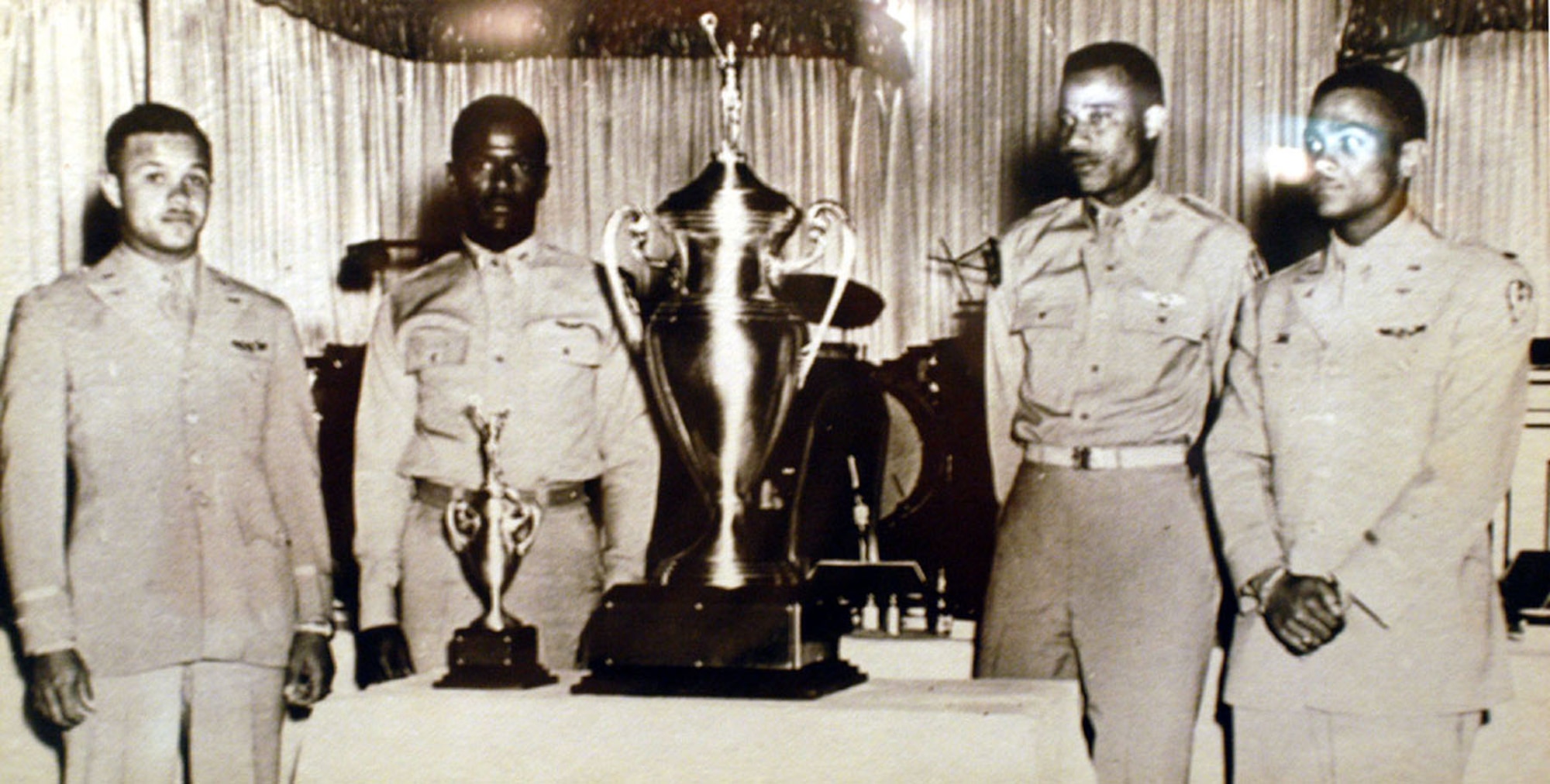 U.S. Air Force Capt. Alva Temple, 1st Lt. James Harvey, 1st Lt. Harry Stewart and 1st Lt. Halbert Alexander pose with their 1949 Weapons Meet trophy in May 1949 at the Flamingo Hotel in Las Vegas, Nev. The trophy went missing for 55 years, but is now displayed at the National Museum of the U.S.Air Force at Wright Patterson Air Force Base, Ohio. (U.S. Air Force photo)