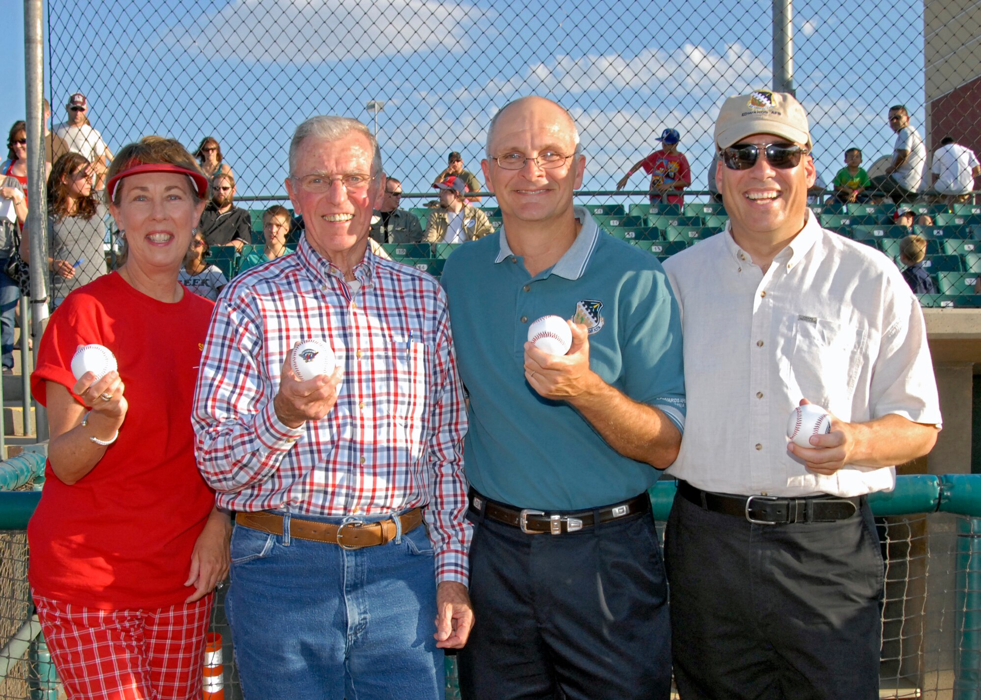 Brig. Gen. Arnold W. Bunch, Air Force Test center commander, along with Brig. Gen. Michael T. Brewer, 412th Test Wing commander, celebrate Aerospace Appreciation NIght with historic X-15 pilot, Joe Engle and Lockheed Martin communications director, Dianne Knippel (left side) before the start of the Lancaster JetHawks game. (Air Force Photo by Laura Mowry)