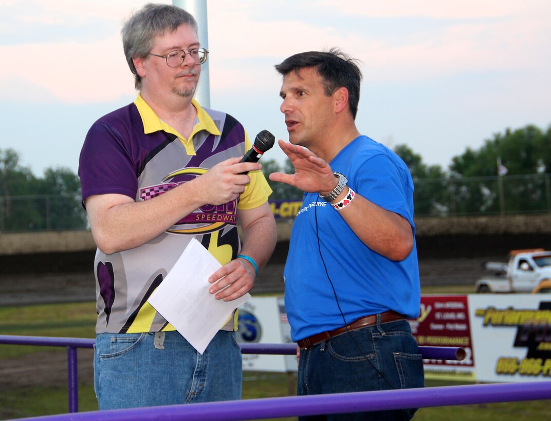 Col.  Albert Lupenski, commander of the 932nd Airlift Wing, speaks to auto racing fans at an area speedway near Granite City, Ill.   Lupenski spoke to the big crowd and was interviewed by track announcer Doug Jenkins just before the races began.  The colonel was also there to cheer the Salty Dog race team, which proudly sports the Air Force Reserve logo on its hood. The Salty Dog race team is owned by Bob Salter, a retired senior NCO and former 932nd AW member.  The 932nd AW is the only Air Force Reserve unit that flies the C-40C.  (U.S. Air Force photo/Tech. Sgt. Dan Oliver)