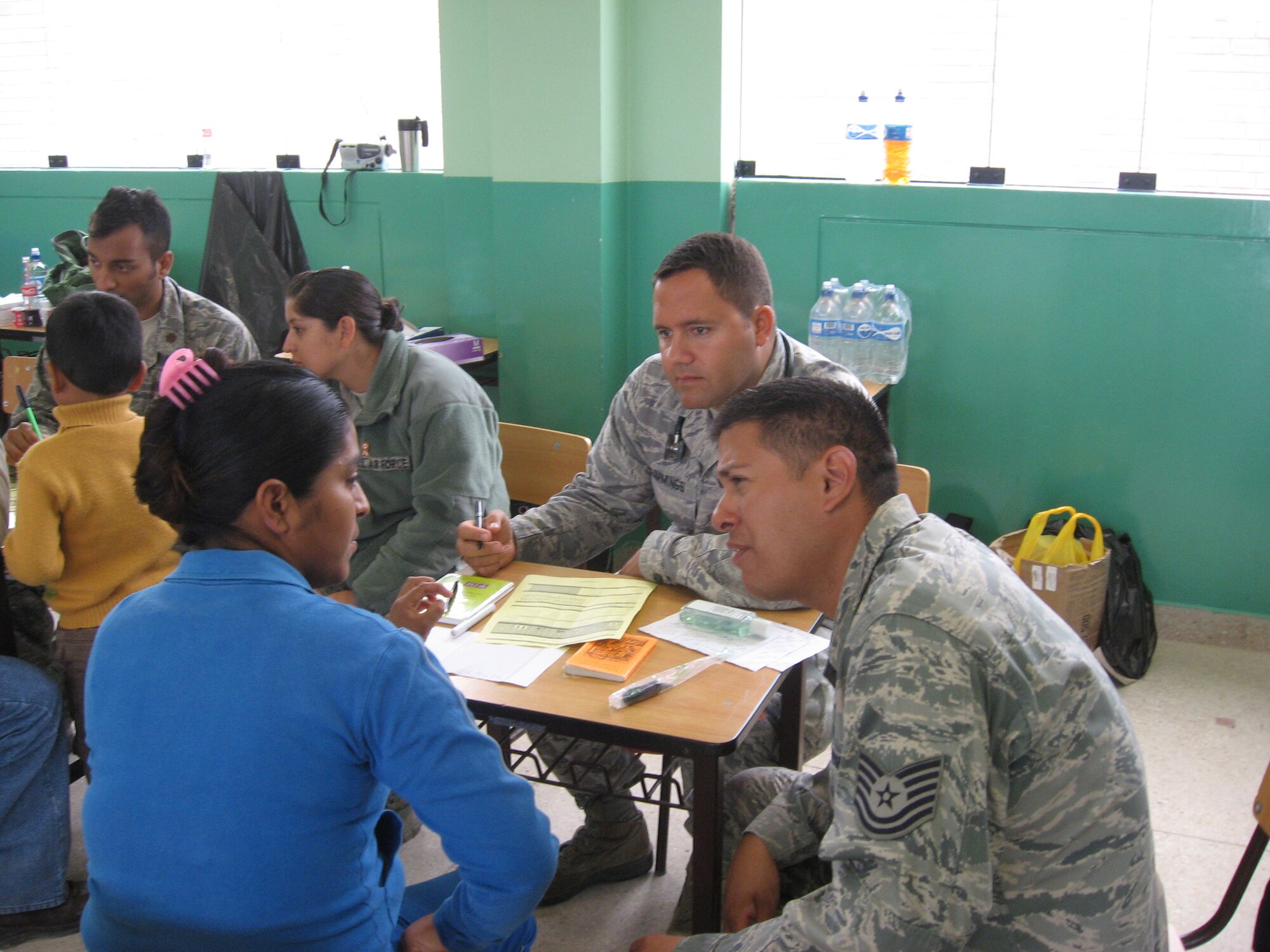 Medical administrator Tech. Sgt. Leonardo Garza Jr., interprets for internal medicine physician Maj. (Dr.) Justin Cummings as he interviews a patient during a medical readiness exercise July 16-26, 2012, in Peru. Both are members of the 81st Medical Operations Squadron, Keesler Air Force Base, Miss.  (U.S. Air Force photo by Maj. Ronald Eller)