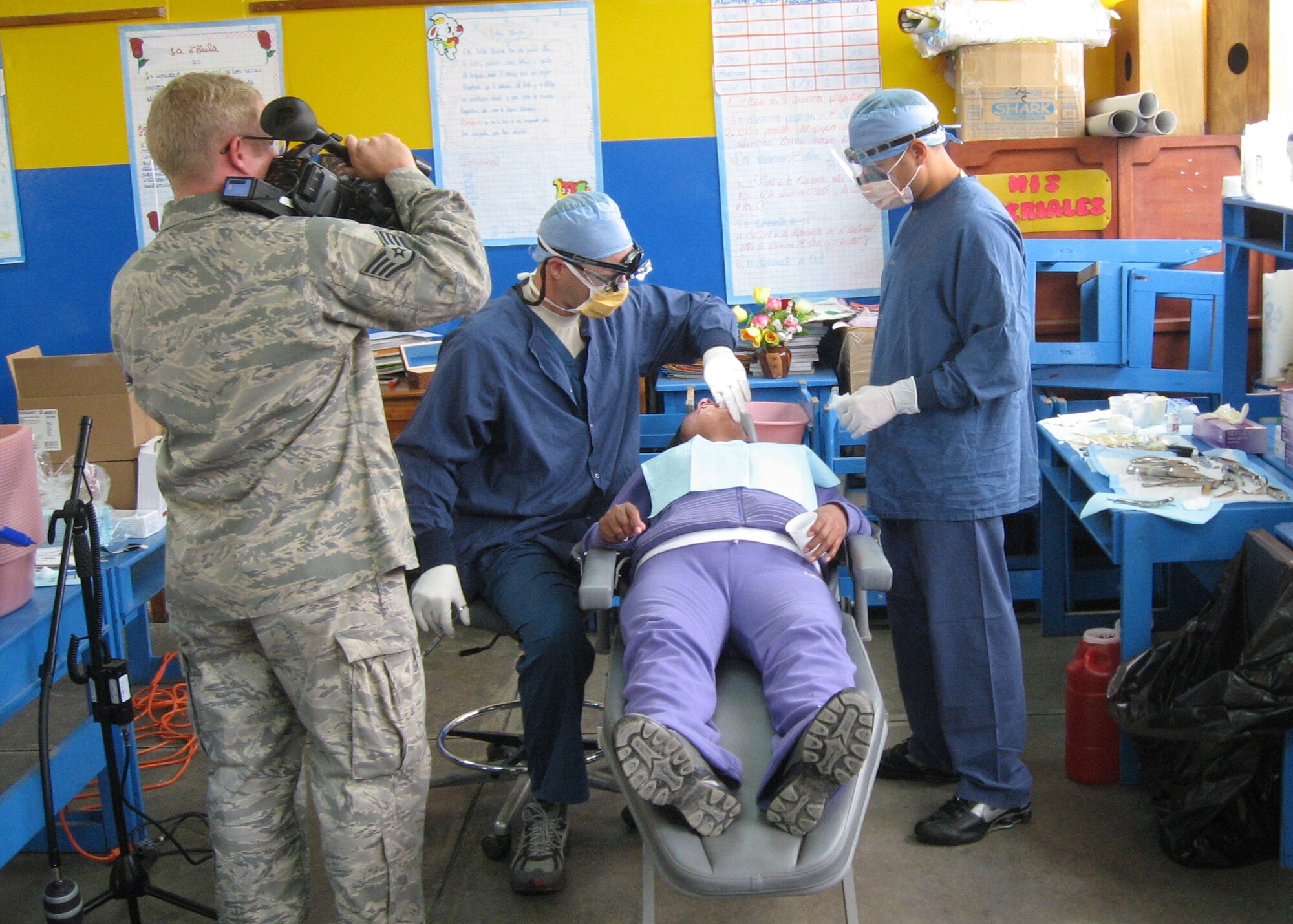 Members from the 81st Dental Squadron, Keesler Air Force Base, Miss., Maj. (Dr.) Stephen Gasparovich and Staff Sgt. Jacob Broersma, treat a patient and an Air Force combat camera videographer tapes them during a medical readiness exercise July 16-26, 2012, in Peru. The dentists saw 1,156 patients and performed 549 extractions during the exercise.  (U.S. Air Force photo by Maj. Ronald Eller)