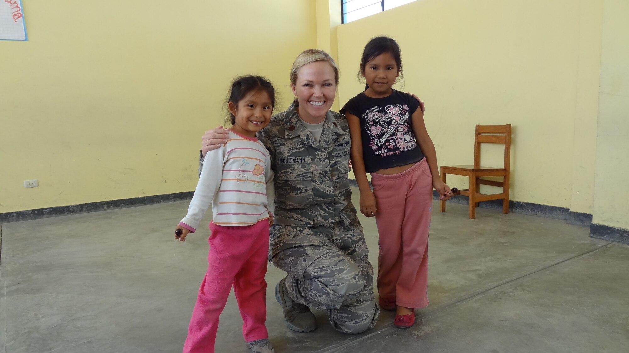 Maj. (Dr.) Wendi Wohltmann, 81st Diagnostics and Therapeutics Squadron, Keesler Air Force Base, Miss., poses for a photo with two Peruvian children July 21, 2012, during a medical readiness exercise in Peru. Wohltmann was one of seventeen 81st Medical Group members that participated in the exercise and humanitarian effort July 16-26.  (U.S. Air Force photo by Maj. Ronald Eller)