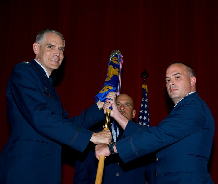 Lt. Col. Scott Minton, 912th Air Refueling Squadron incoming commander, takes command of the 912th ARS from Lt. Col. Brice Middleton, 912th ARS outgoing commander, July 21, during a change of command ceremony in the Cultural Resource Center. Col. Shawn Teagan, 92nd Operations Group commander, Fairchild AFB, Wash., presided over the event. Senior Master Sgt. Eric Butt, 912th ARS first sergeant, holds the guidon which symbolizes the transfer of authority from the old to the new commander. (U.S. Air Force photo by Staff Sgt. Matthew Smith) 