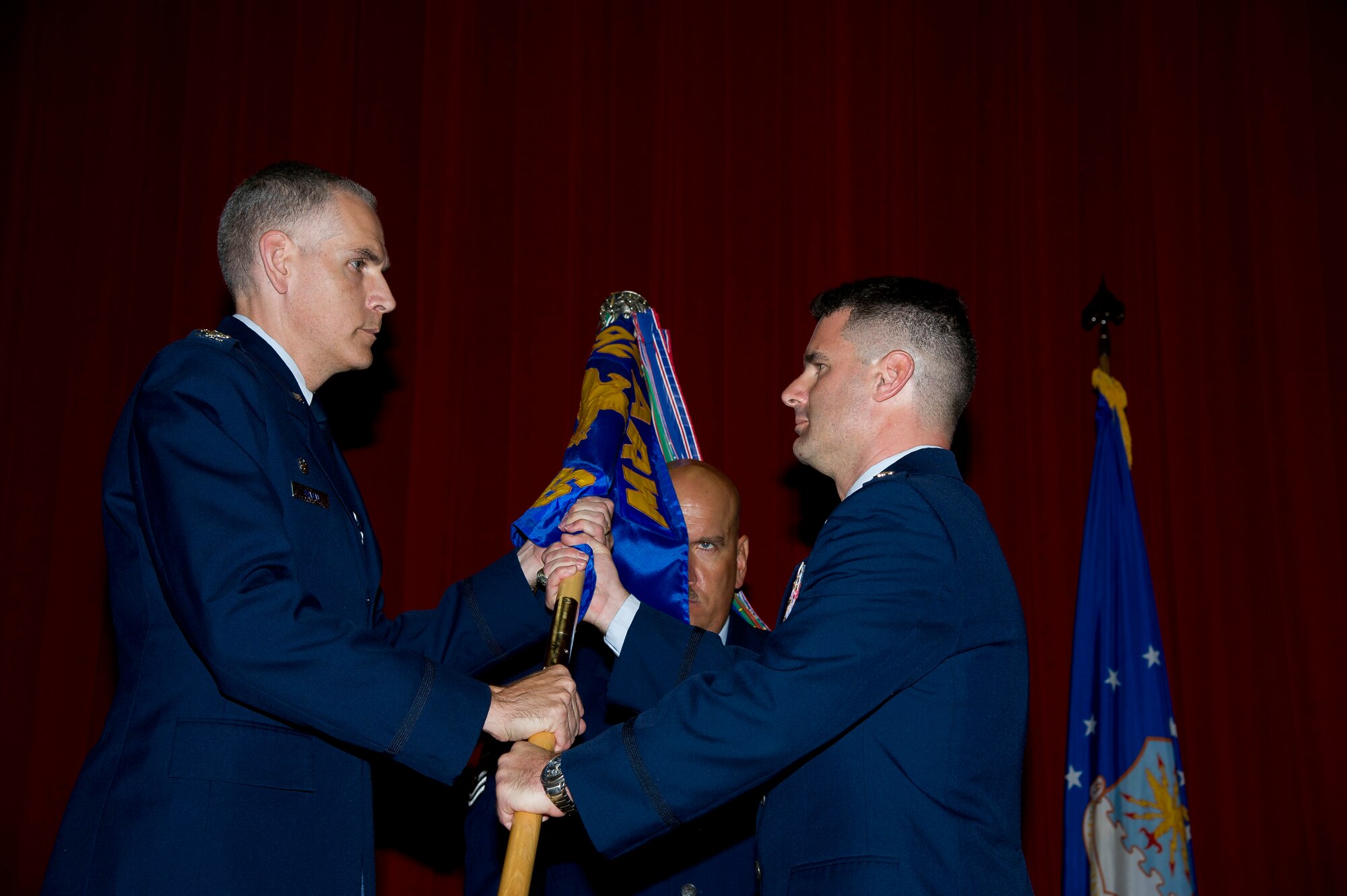 Lt. Col. Scott Minton, 912th Air Refueling Squadron incoming commander, takes command of the 912th ARS from Lt. Col. Brice Middleton, 912th ARS outgoing commander, July 21, during a change of command ceremony in the Cultural Resource Center. Col. Shawn Teagan, 92nd Operations Group commander, Fairchild AFB, Wash., presided over the event. Senior Master Sgt. Eric Butt, 912th ARS first sergeant, holds the guidon which symbolizes the transfer of authority from the old to the new commander. (U.S. Air Force photo by Staff Sgt. Matthew Smith) 