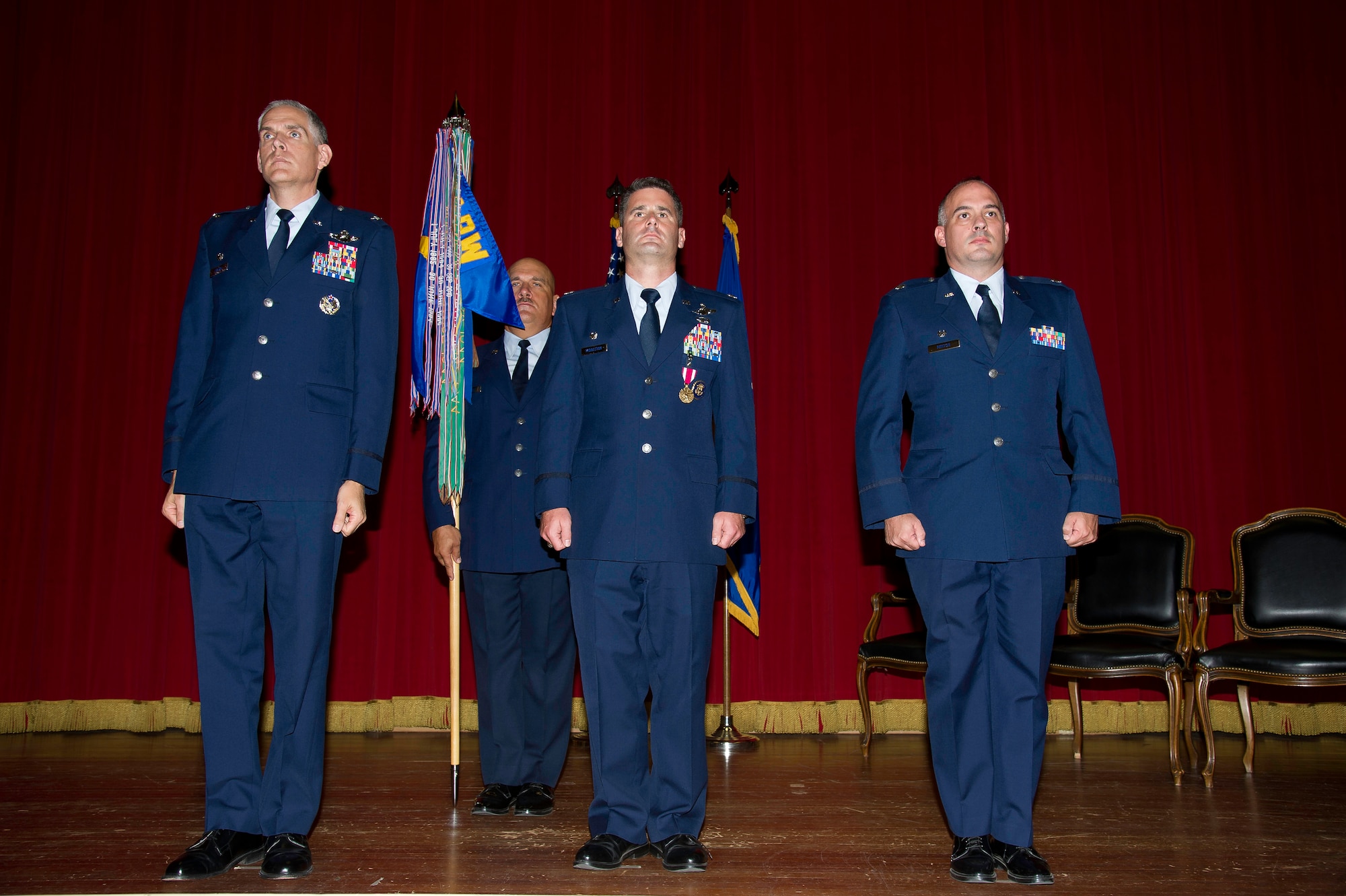 Lt. Col. Scott Minton, right, 912th Air Refueling Squadron incoming commander, prepares to take command of the 912th ARS from Lt. Col. Brice Middleton, center, 912th ARS outgoing commander, July 21, during a change of command ceremony in the Cultural Resource Center. Col. Shawn Teagan, left, 92nd Operations Group commander, Fairchild AFB, Wash., presided over the event. Senior Master Sgt. Eric Butt, 912th ARS first sergeant, holds the guidon which symbolizes the transfer of authority from the old to the new commander. (U.S. Air Force photo by Staff Sgt. Matthew Smith)
