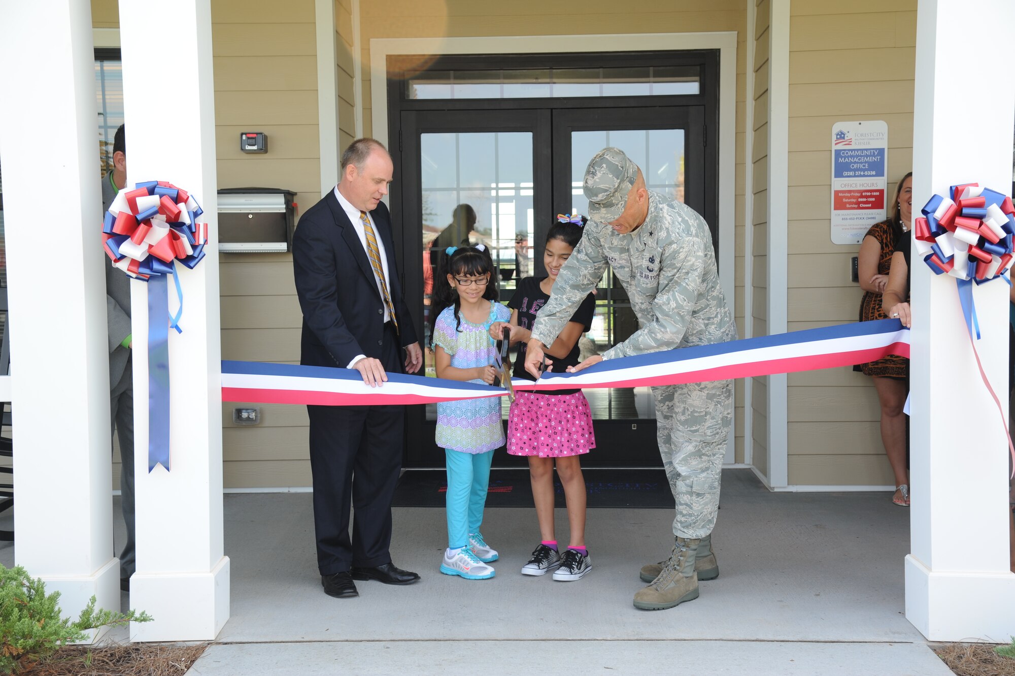 John Hoyt, vice president of Forest City Military Communities and the project executive for the Air Force’s Southern Group privatized housing program, Yesiann Morales, 7, and her sister, Angelee, 11, and Brig. Gen. Bradley Spacy, 81st Training Wing commander, participate in the Keesler Community Center ribbon-cutting ceremony August 7, 2012, at the Bay Ridge Housing area, Keesler Air Force Base, Miss.  Yesiann was one of three winners in an art contest for the center and Angelee was the winner of the essay contest.  They are the daughters of Yoseline and Staff Sgt. Pedro Morales, 338th Training Squadron.  The facility features an event room, business center, fitness room with a children’s play area, an outdoor swimming pool and a splash pad.  (U.S. Air Force photo by Kemberly Groue)