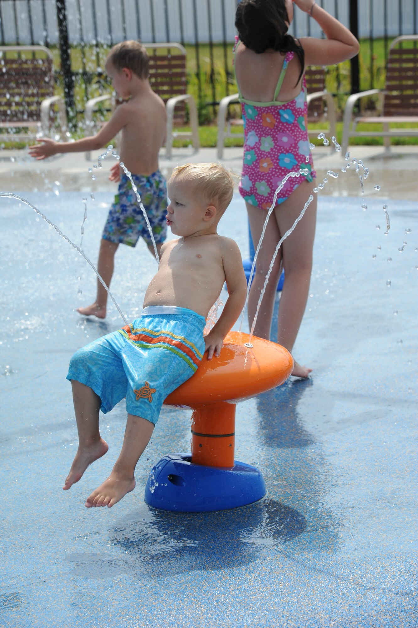 Three-year-old Eli Williams, son of Kim and Lt. Col. Jason Williams, 345th Airlift Squadron, takes advantage of the splash pad at the Keesler Community Center in the Bay Ridge housing area August 7, 2012, at Keesler Air Force Base, Miss.  The center celebrated its opening with a ribbon-cutting ceremony and a tour of the facility, which also features an event room, business center, fitness room with a children’s play area, and an outdoor swimming pool.  (U.S. Air Force photo by Kemberly Groue)