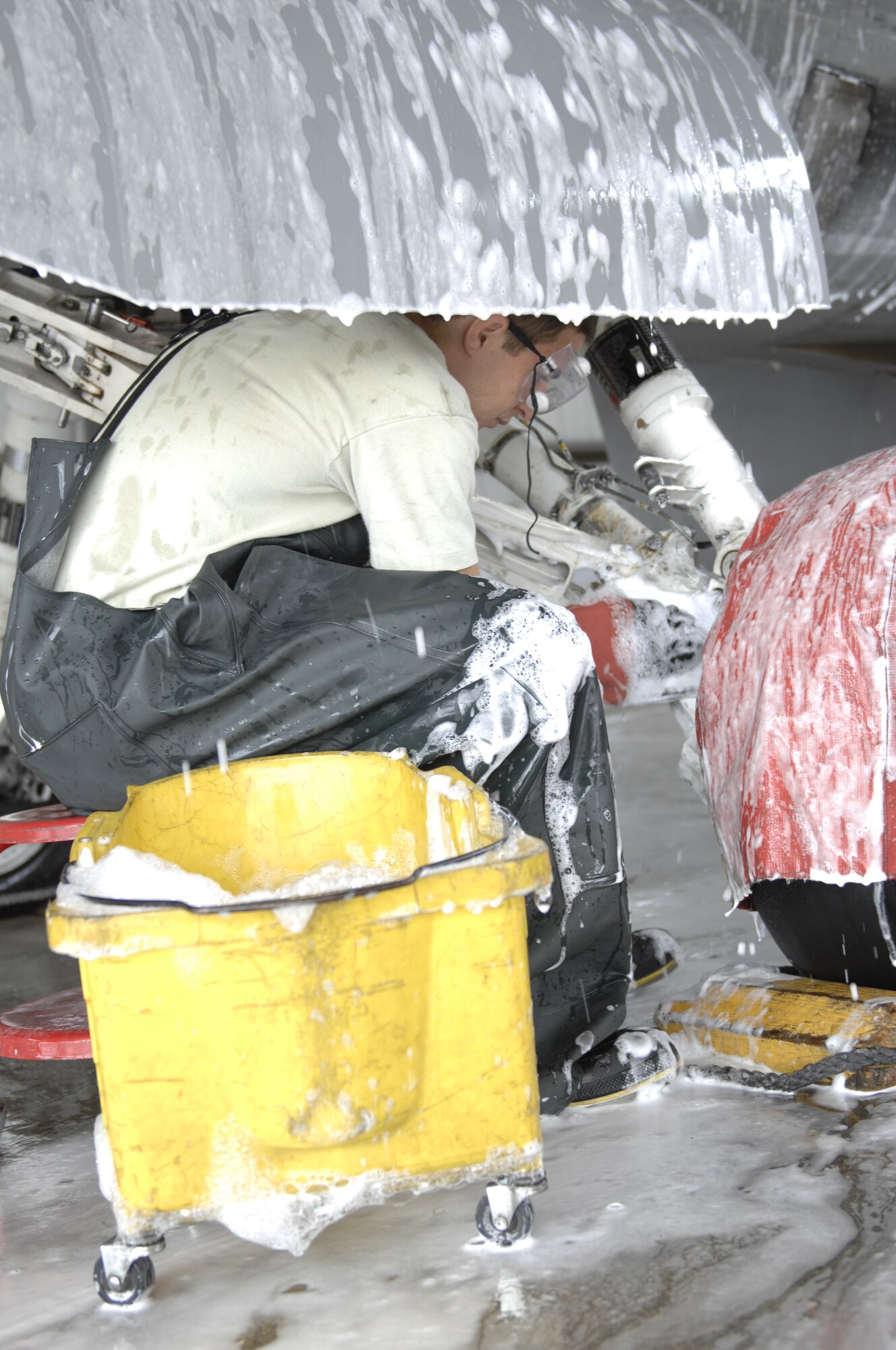 Airman 1st Class Jake Palmiero, 20th Aircraft Maintenance Squadron, Gamblers Aircraft Maintenance Unit electrical environmental specialist and a native of Kenmore, N.Y., washes the landing gear of an F-16 Fighting Falcon at Shaw Air Force Base, S.C., July 31, 2012. F-16s are cleaned twice a year of oil, grime and environmental debris to prevent corrosion. Corrosion can cause a landing failure by causing the wheels to crack and jeopardizing the strength the landing gear. (U.S. Air Force photo by Airman 1st Class Krystal M. Jeffers/Released)