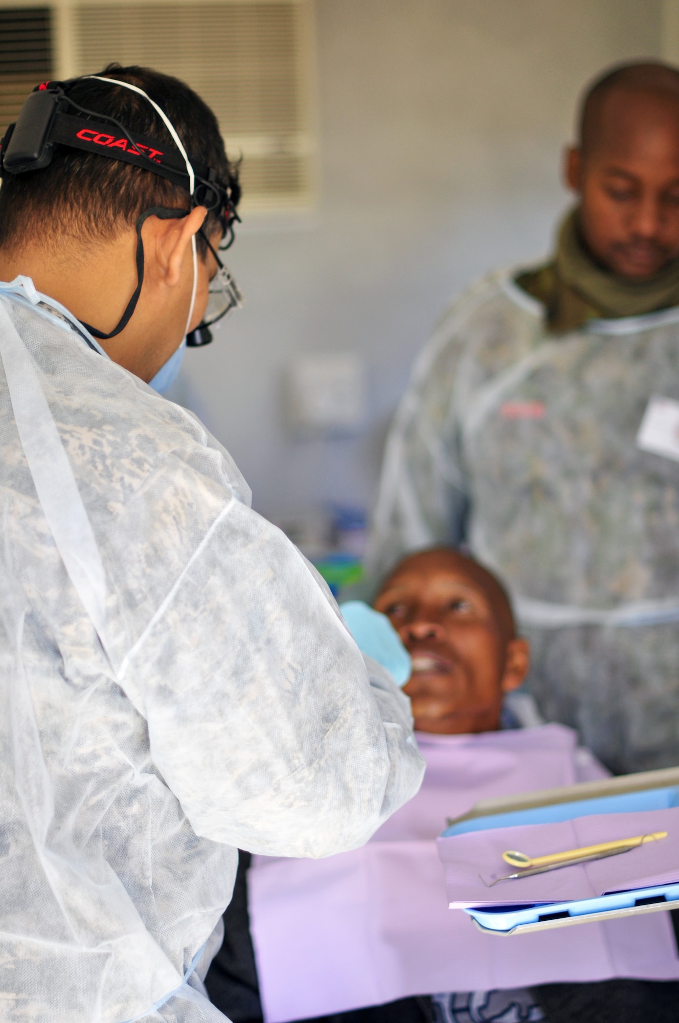 THEBEPHATSWA AIR BASE, Botswana -- Lt. Col. Enrique Rosado (left), an International Health Specialist dentist from U.S. Air Forces Africa, and Capt. Baputaki Kopano, Botswana Defense Force dental therapist, examine a patient during a humanitarian civilian assistance at Malwelwe village, Aug. 7, 2012. The HCA was provided by MEDLITE/SOUTHERN ACCORD 12, a key element in a broader series of military-to-military activities that demonstrate the strong partnership between the U.S. and BDF forces. (U.S. Air Force photo/Tech. Sgt. Chad Thompson)