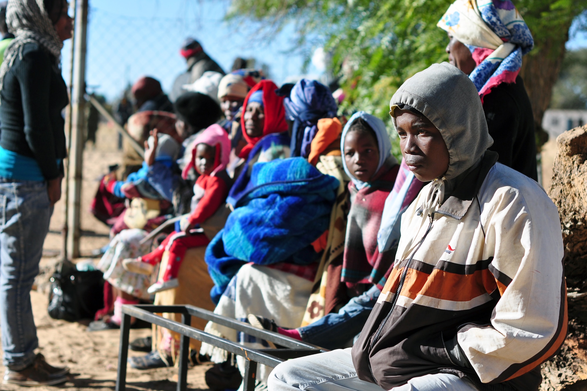 THEBEPHATSWA AIR BASE, Botswana -- Family and community members of Malwelwe village gather to receive medical treatment during a humanitarian civilian assistance Aug. 7, 2012. The HCA was provided by MEDLITE/SOUTHERN ACCORD 12, a key element in a broader series of military-to-military activities that demonstrate the strong partnership between the U.S. and BDF forces. (U.S. Air Force photo/Tech. Sgt. Chad Thompson)