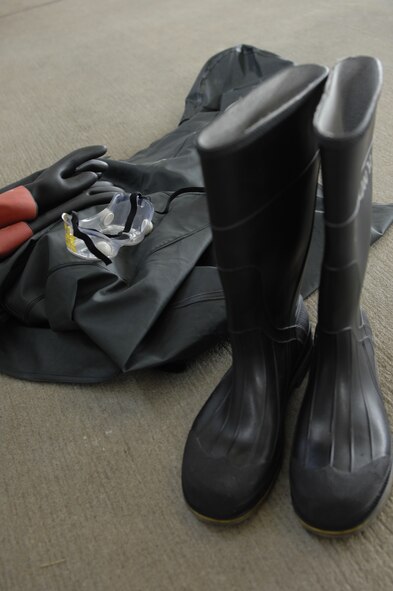 Displayed are examples of the goggles, gloves, boots, overalls and the jacket Airmen wear to protect themselves from the soap used to wash an F-16 Fighting Falcon at Shaw Air Force Base, S.C., July 31, 2012. Each plane is washed clean of grime and environmental build-up every 180 days to prevent corrosion from weakening its structure. (U.S. Air Force photo by Airman 1st Class Krystal M. Jeffers/Released)