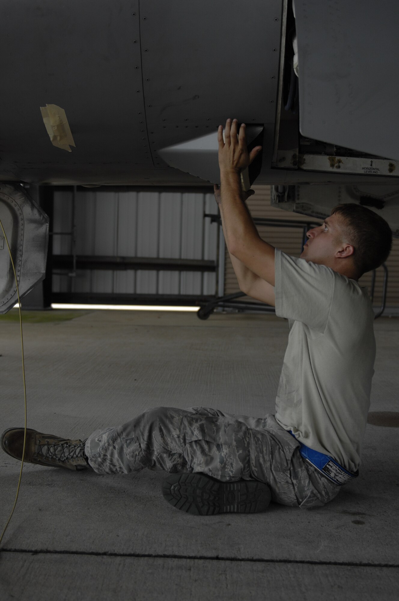 Staff Sgt. Kyle Padgett, 20th Aircraft Maintenance Squadron, Gamblers Aircraft Maintenance Unit dedicated crew chief and a native of Aiken, S.C., places tape over sensitive electrical equipment on an F-16 Fighting Falcon before it is washed at Shaw Air Force Base, S.C., July 31, 2012. Aircraft are washed every 180 days to prevent corrosion from weakening the structure of the plane. The three- hour process of washing an F-16 includes applying tape, washing, removing the tape and checking the paint for corrosion. (U.S. Air Force photo by Airman 1st Class Krystal M. Jeffers/Released)